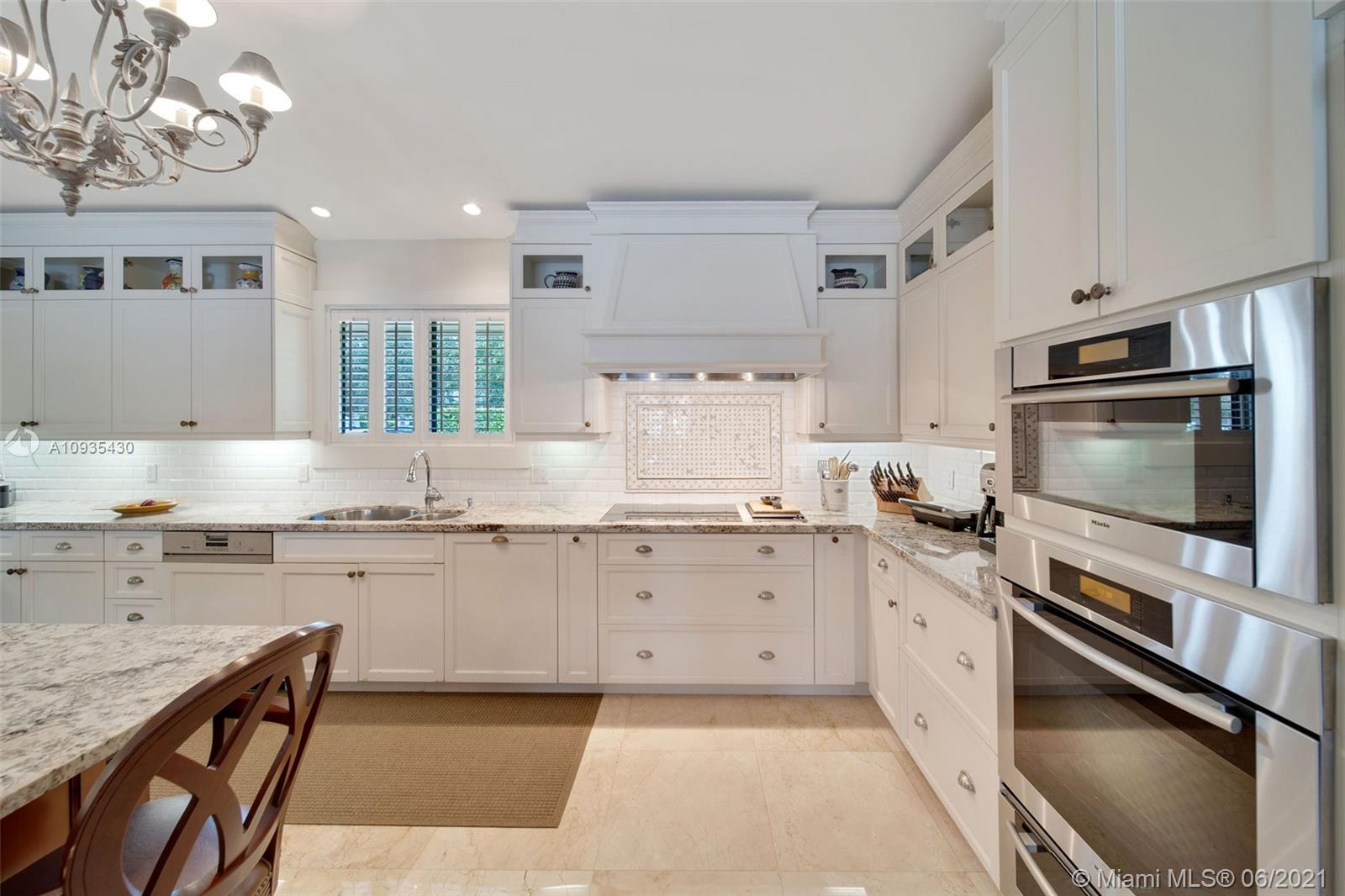 4804 Biltmore Drive Coral Gables, FL 33146 - Photo 10 of 47 a kitchen with granite countertop cabinets stainless steel appliances and a counter space