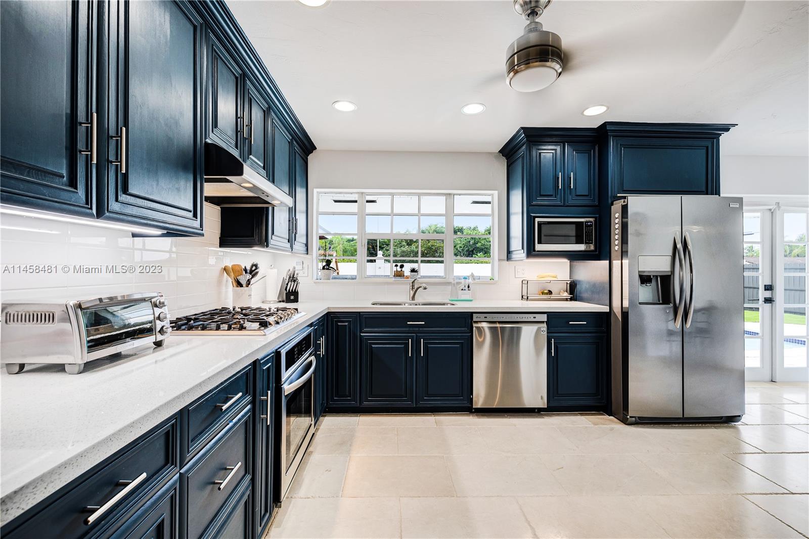 10520 Southwest 103rd Avenue Miami, FL 33176 - Photo 13 of 51 a kitchen with stainless steel appliances granite countertop a sink a stove a refrigerator cabinets a sink and a oven