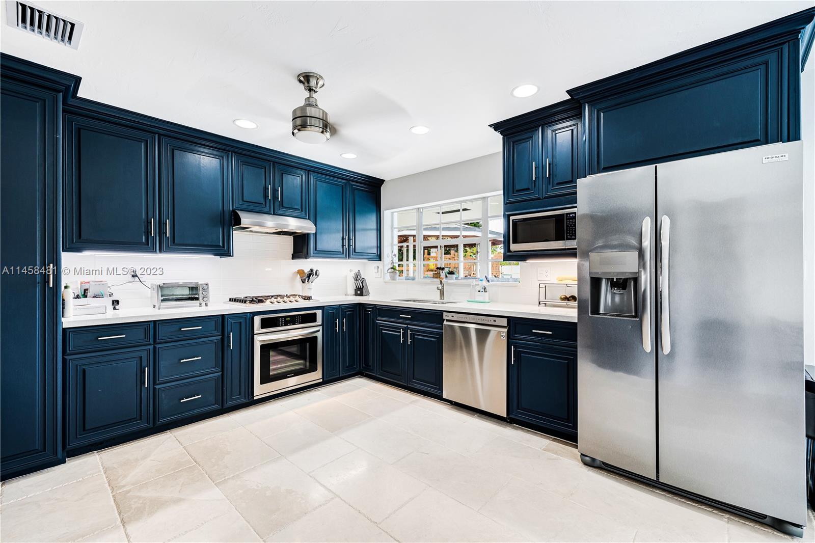 10520 Southwest 103rd Avenue Miami, FL 33176 - Photo 14 of 51 a kitchen with granite countertop stainless steel appliances a refrigerator sink and cabinets