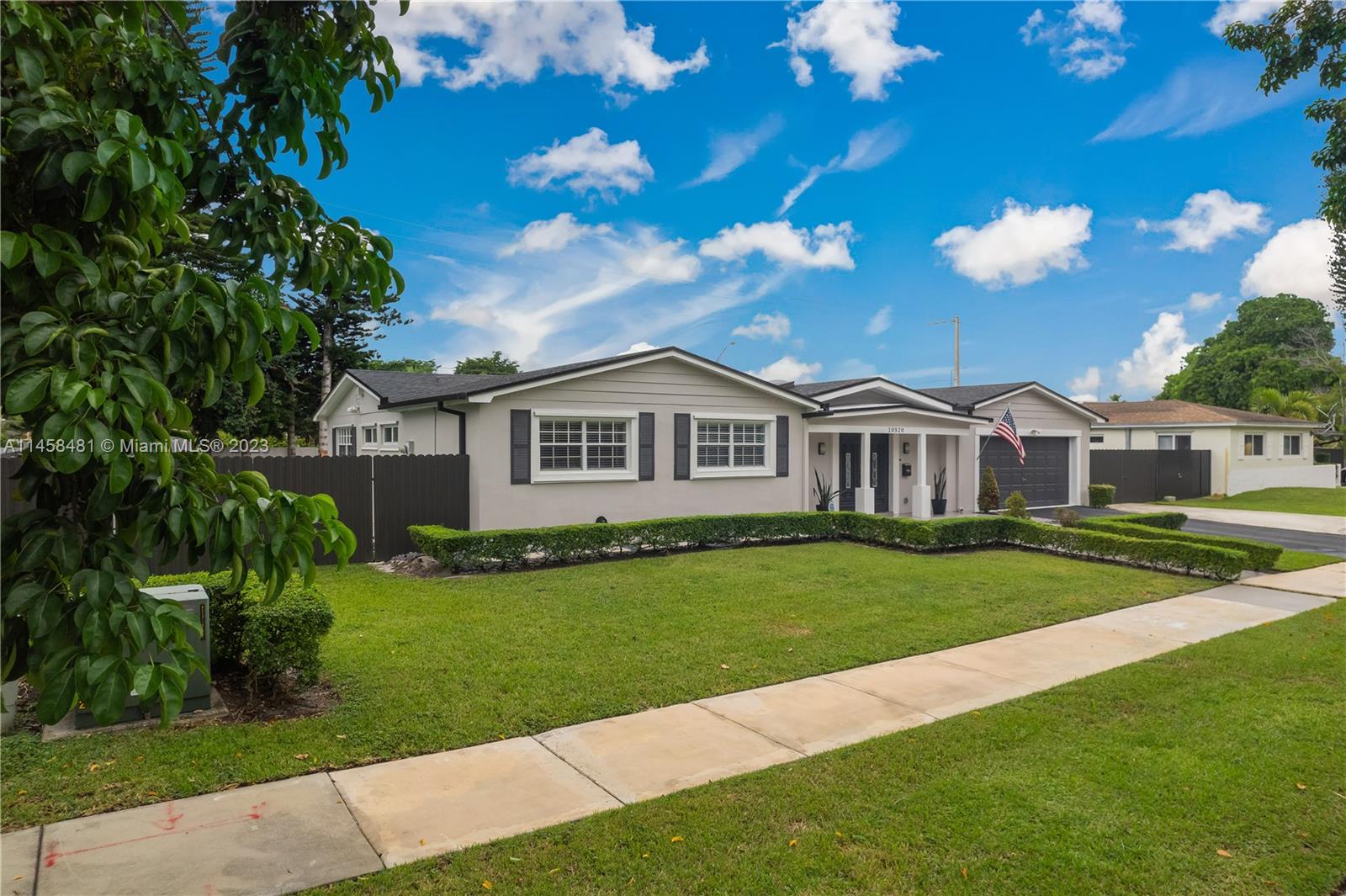 10520 Southwest 103rd Avenue Miami, FL 33176 - Photo 2 of 51 a front view of a house with garden