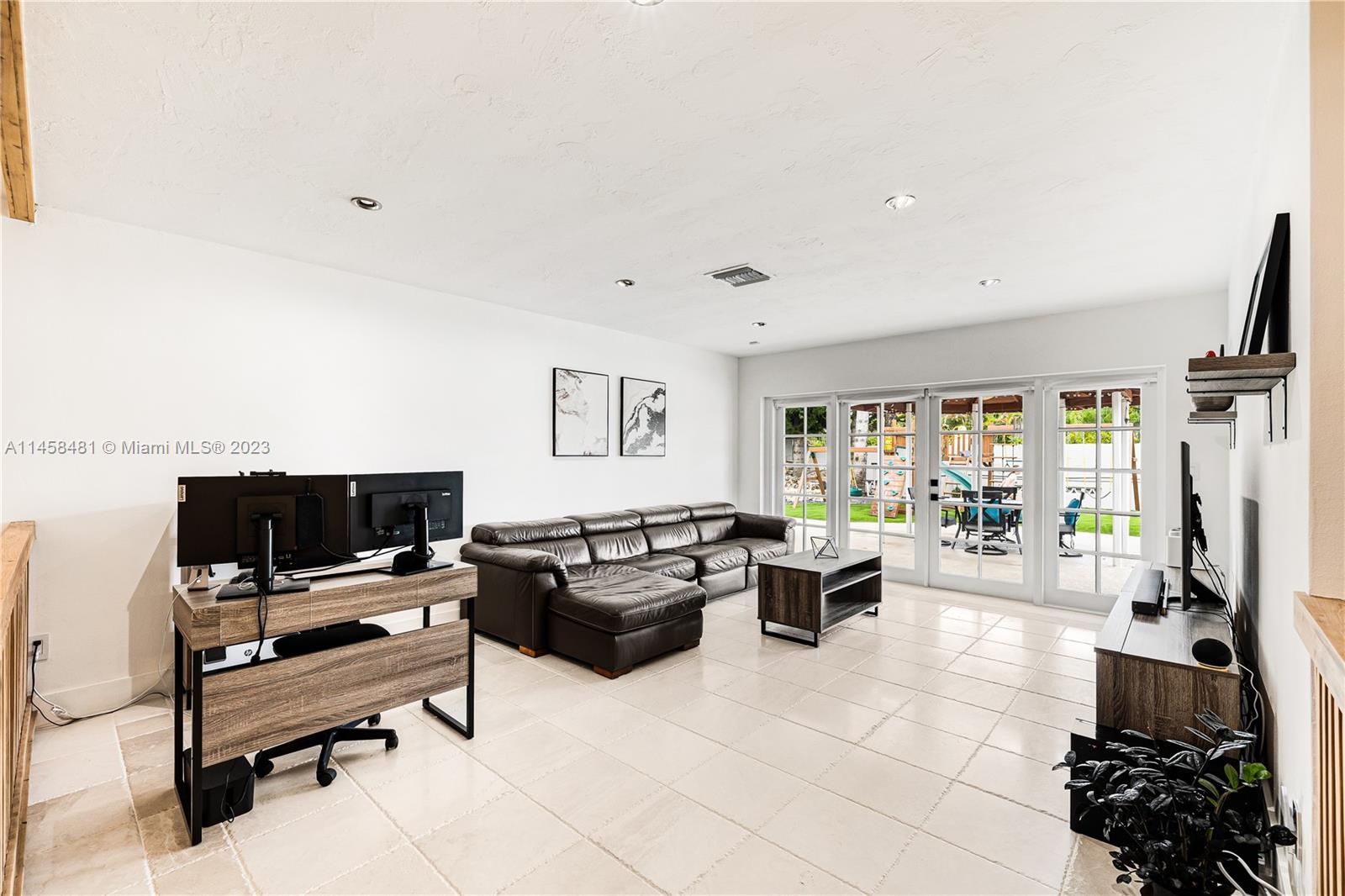 10520 Southwest 103rd Avenue Miami, FL 33176 - Photo 21 of 51 a living room with furniture large window and flat screen tv