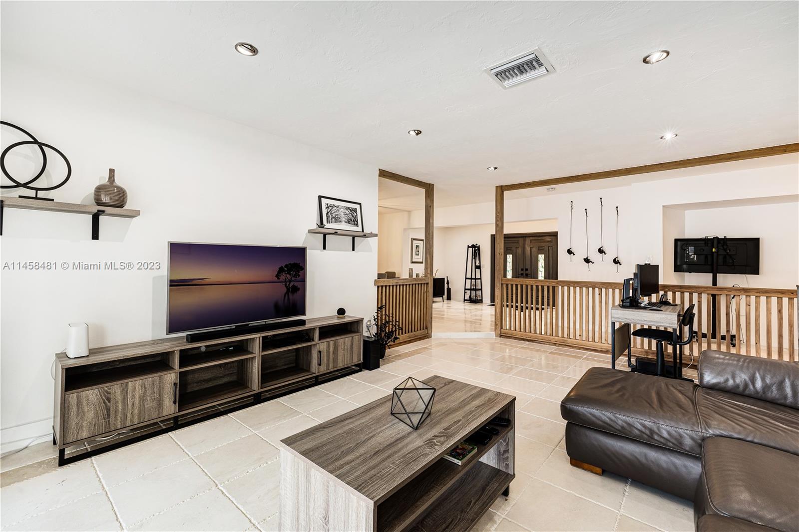 10520 Southwest 103rd Avenue Miami, FL 33176 - Photo 23 of 51 a living room with furniture and a flat screen tv