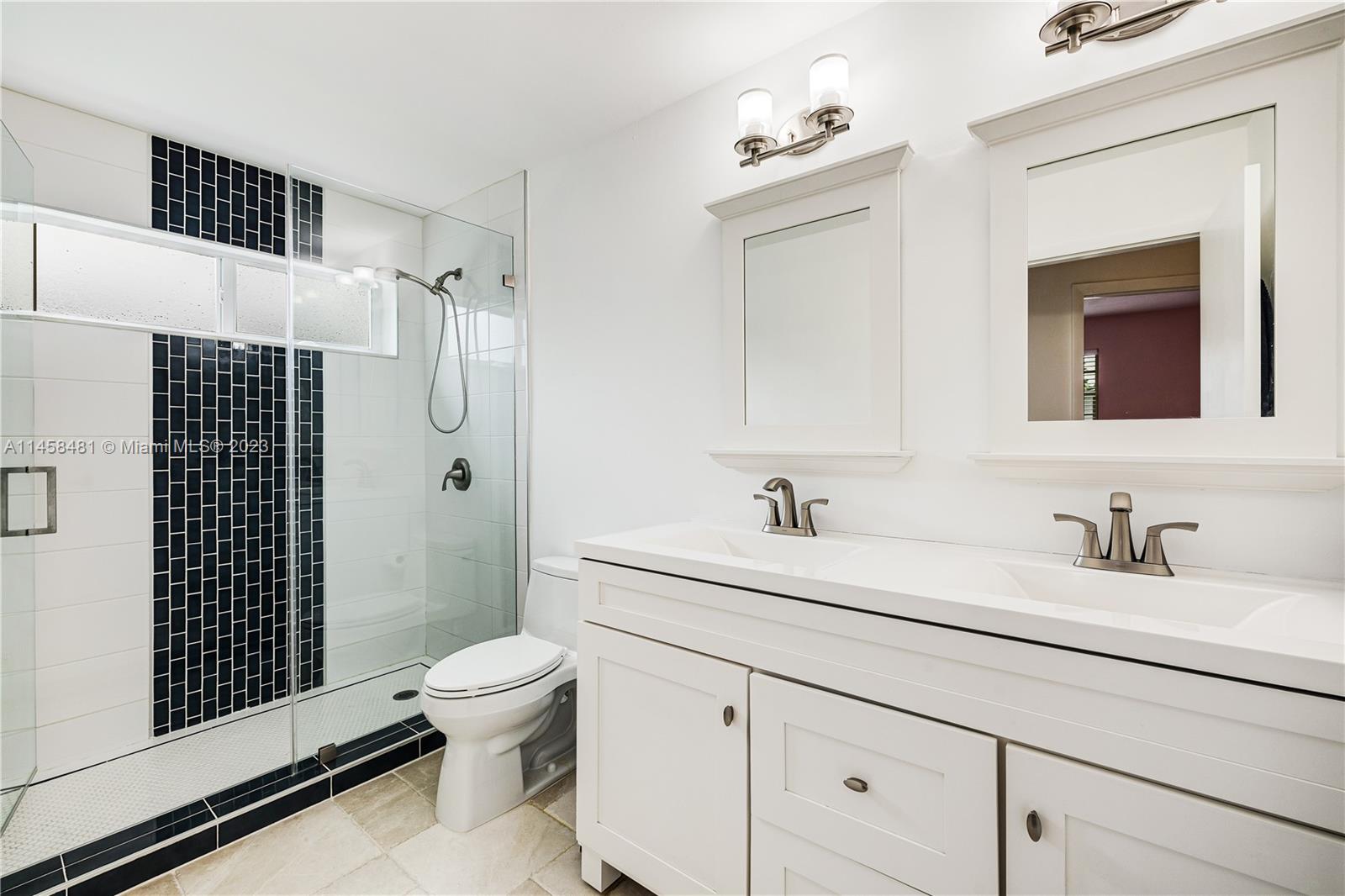 10520 Southwest 103rd Avenue Miami, FL 33176 - Photo 26 of 51 a bathroom with a granite countertop sink toilet a mirror a vanity and shower