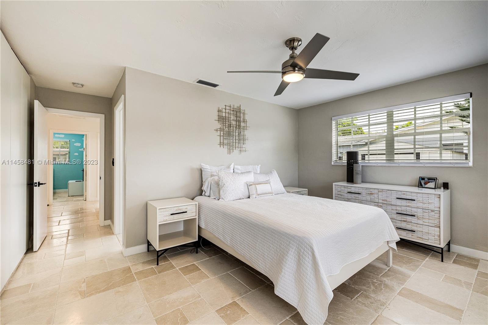 10520 Southwest 103rd Avenue Miami, FL 33176 - Photo 31 of 51 a bedroom with a bed and a large window