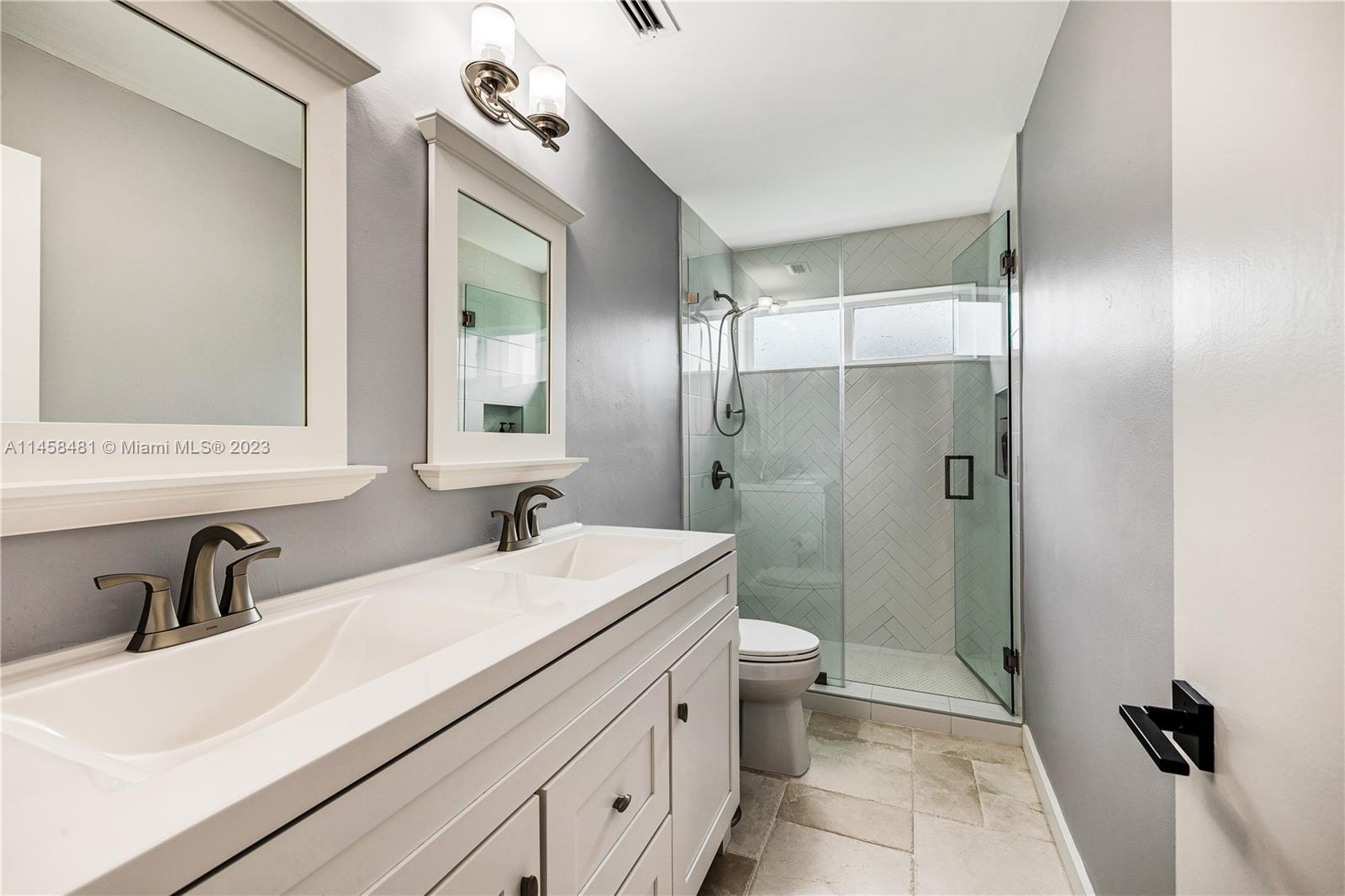 10520 Southwest 103rd Avenue Miami, FL 33176 - Photo 32 of 51 a bathroom with a double vanity sink toilet and shower