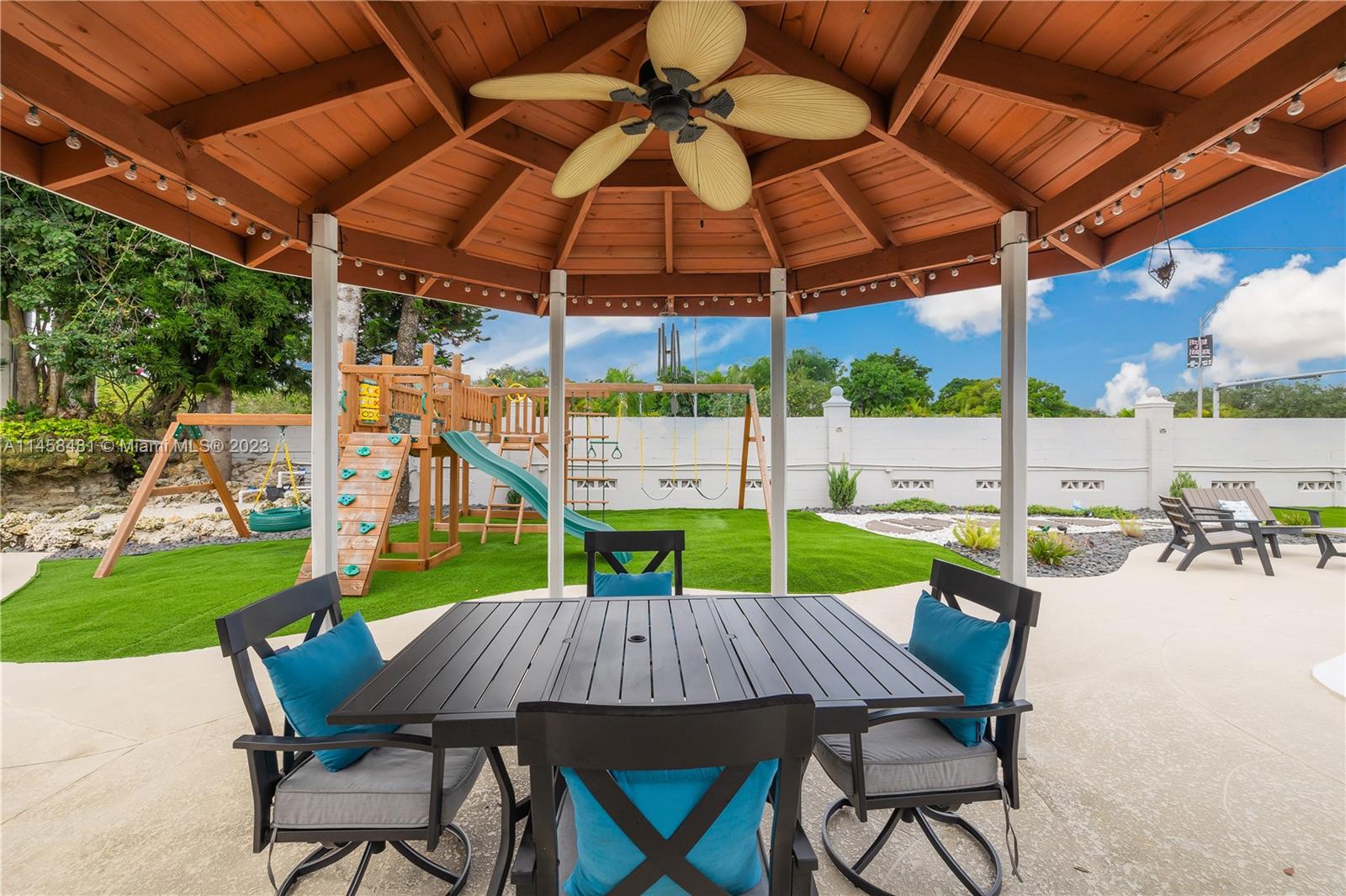 10520 Southwest 103rd Avenue Miami, FL 33176 - Photo 33 of 51 a view of an outdoor sitting area with furniture and umbrella