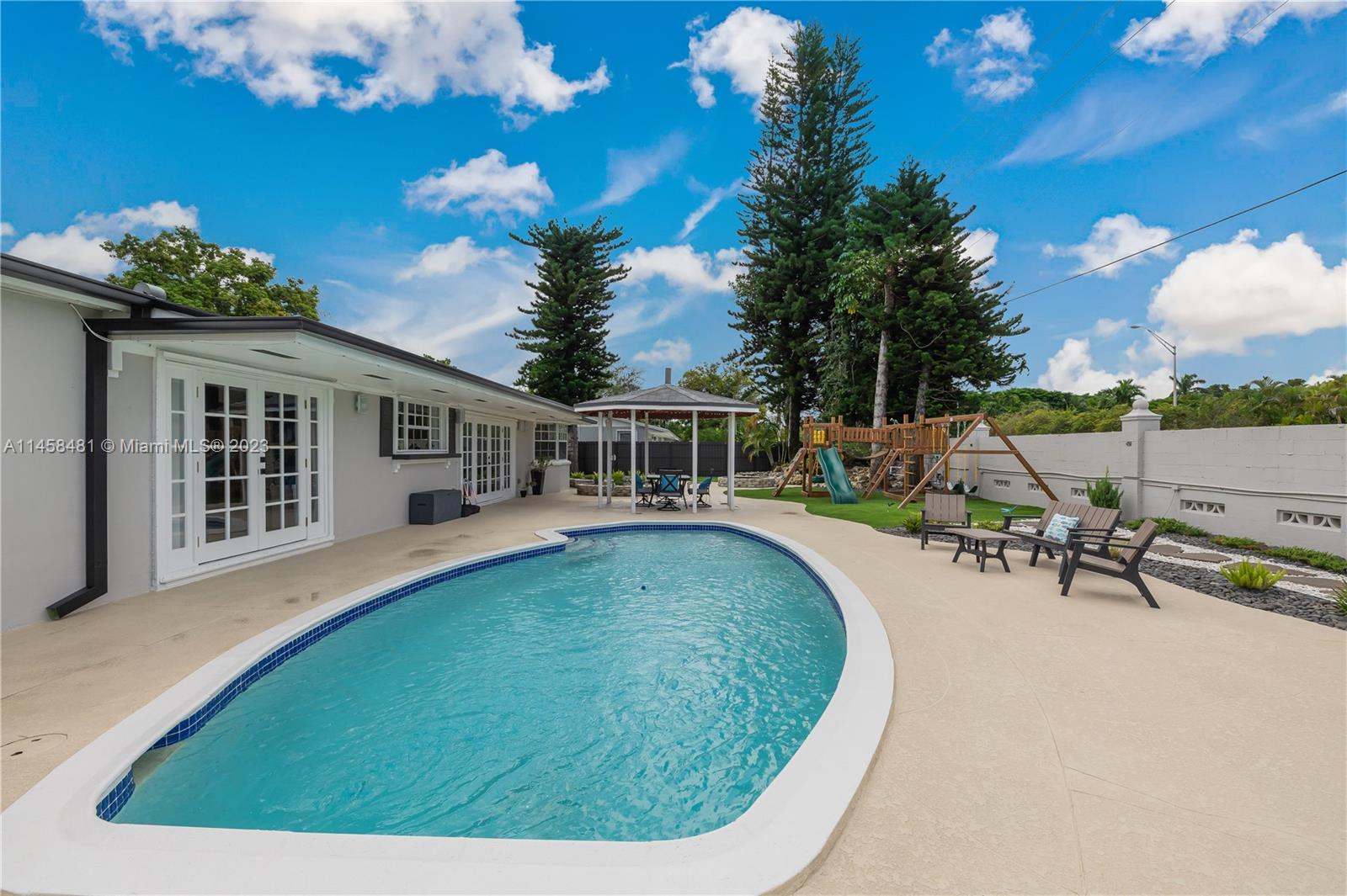 10520 Southwest 103rd Avenue Miami, FL 33176 - Photo 34 of 51 a view of a house with swimming pool and sitting area