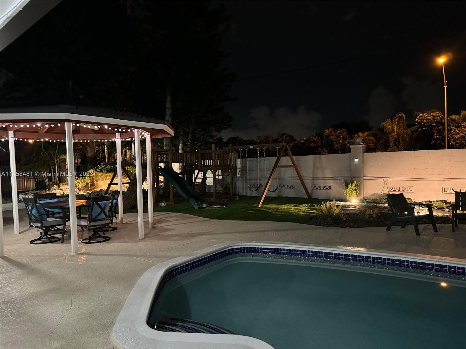 10520 Southwest 103rd Avenue Miami, FL 33176 - Photo 49 of 51 a view of a patio with a table and chairs
