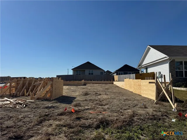 a view of a barn in the middle of a yard