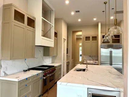 a kitchen with stainless steel appliances granite countertop a stove a sink and a refrigerator