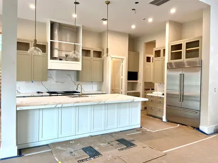 a large kitchen with stainless steel appliances granite countertop a stove and a refrigerator