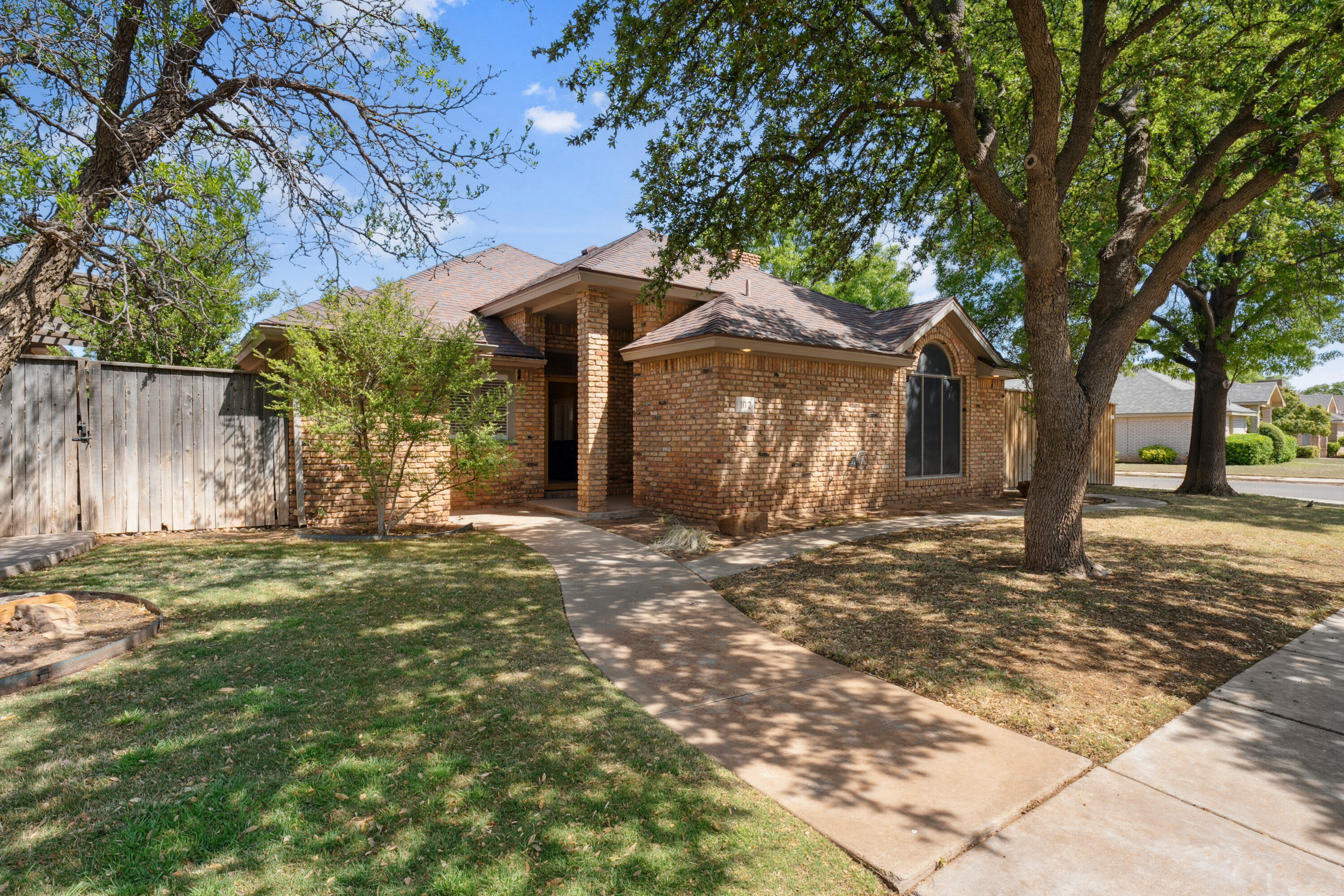 102 North Utica Avenue Lubbock, TX 79416 - Photo 1 of 36 a view of a yard with an tree and fence