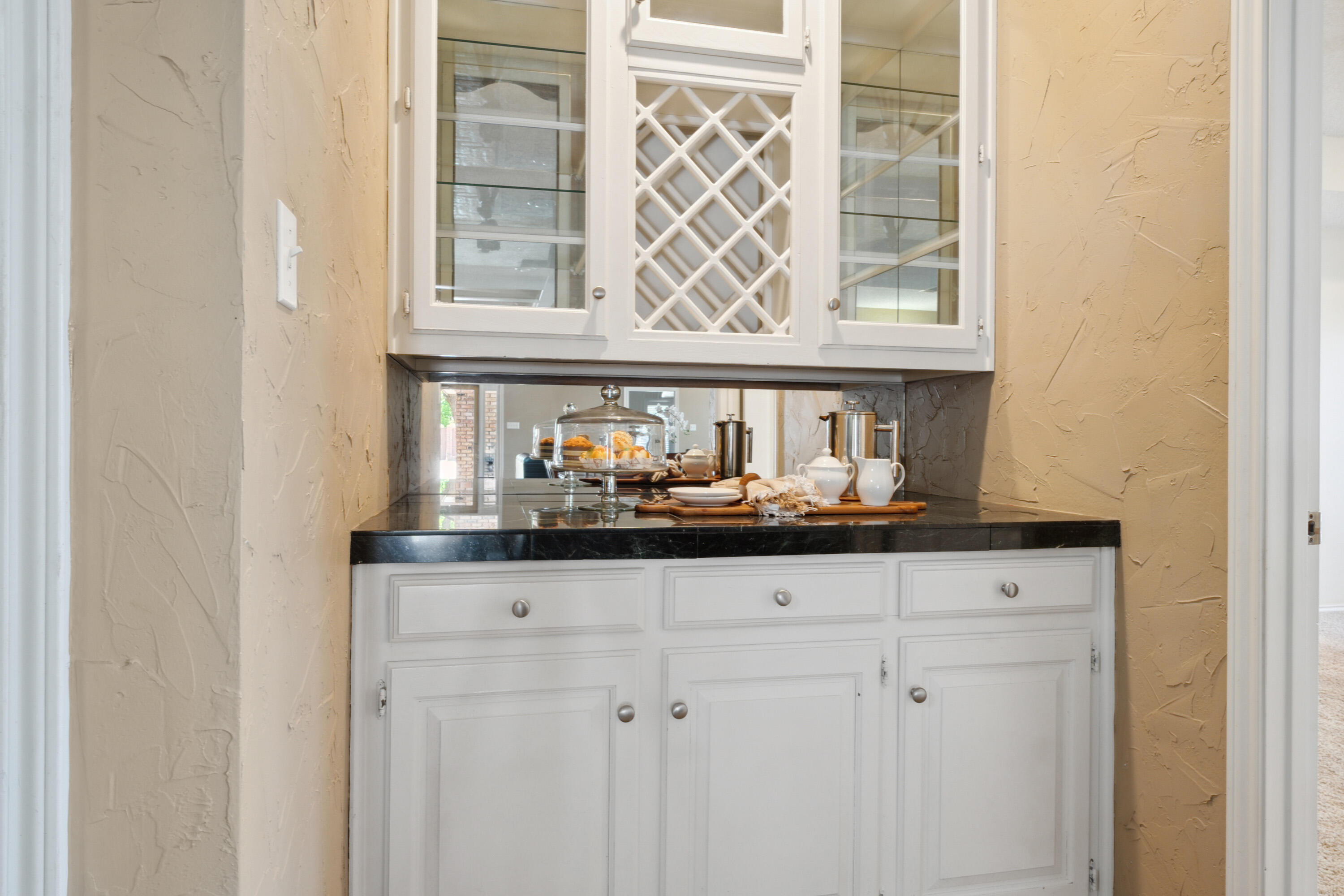 102 North Utica Avenue Lubbock, TX 79416 - Photo 12 of 36 a kitchen with granite countertop white cabinets and a window