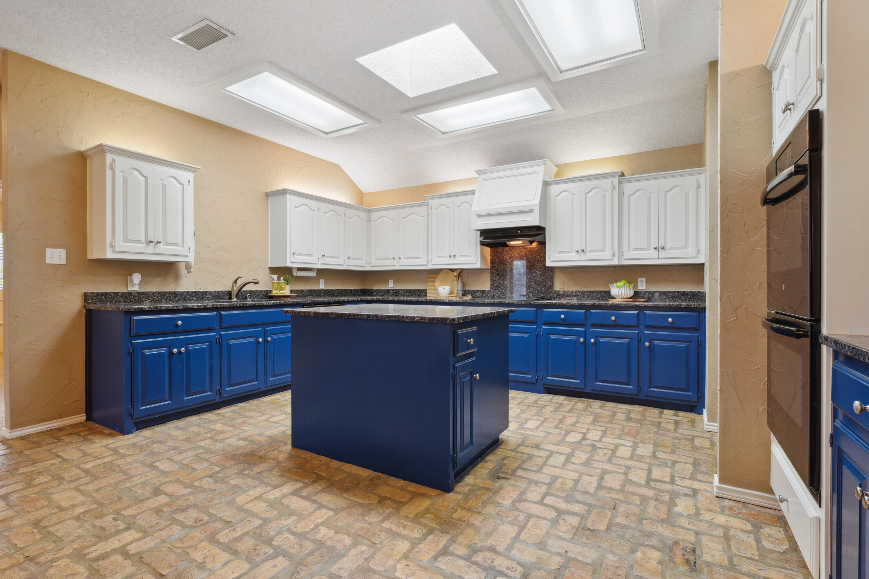 102 North Utica Avenue Lubbock, TX 79416 - Photo 13 of 36 a kitchen with stainless steel appliances granite countertop a stove a refrigerator and a sink