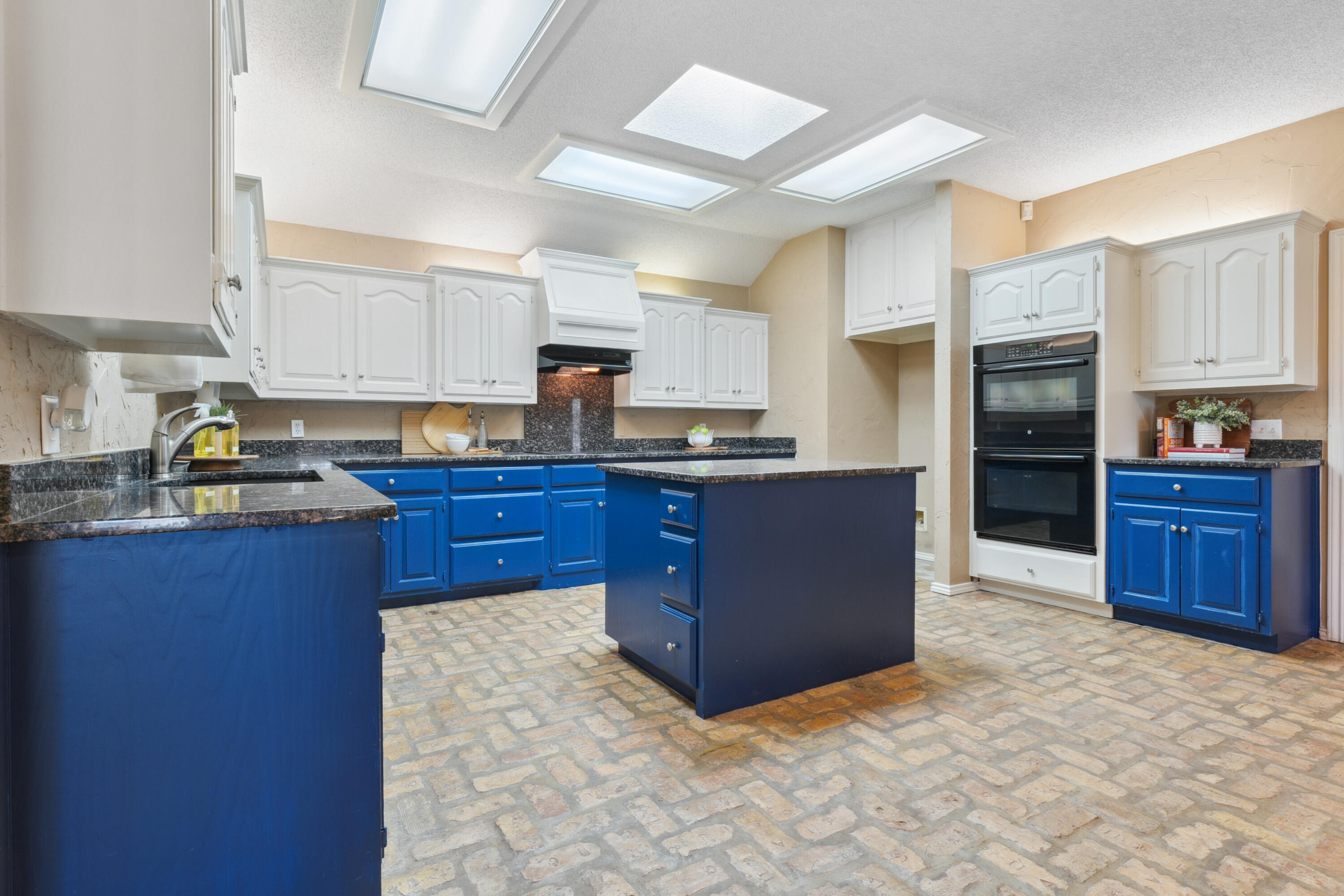 102 North Utica Avenue Lubbock, TX 79416 - Photo 16 of 36 a kitchen with stainless steel appliances a refrigerator and wooden cabinets