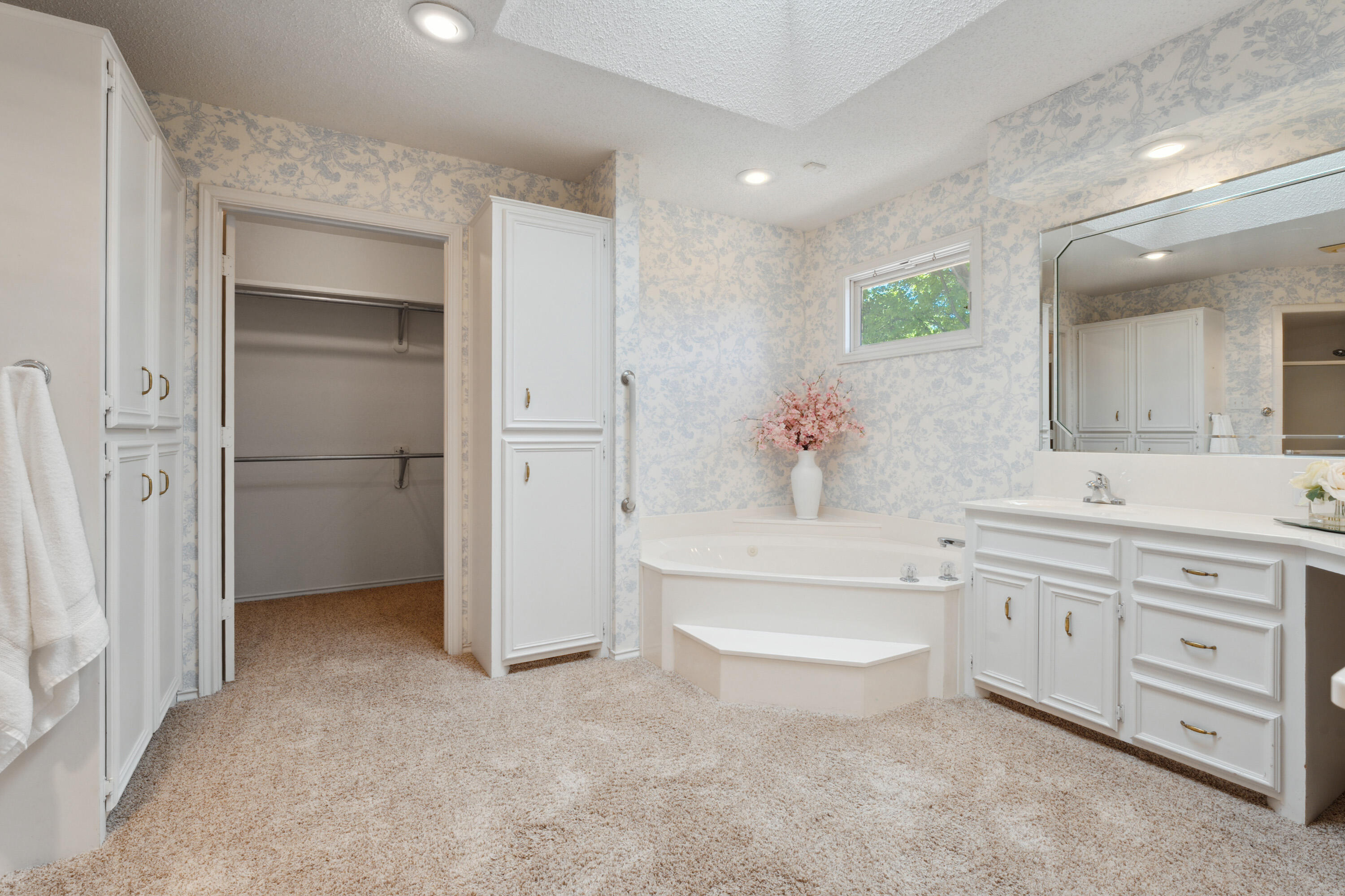 102 North Utica Avenue Lubbock, TX 79416 - Photo 20 of 36 a spacious bathroom with a double vanity sink a mirror and a bathtub