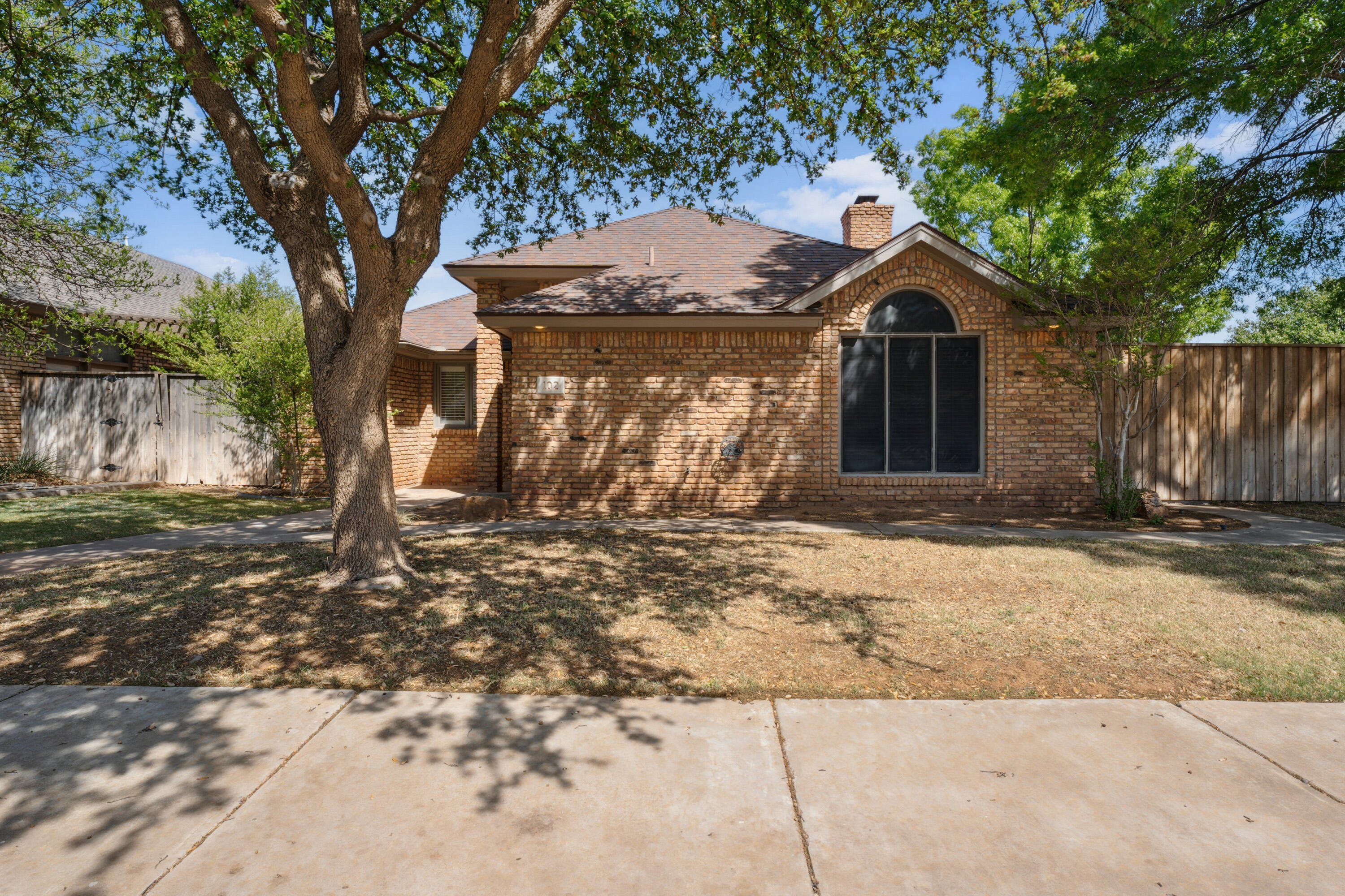 102 North Utica Avenue Lubbock, TX 79416 - Photo 2 of 36 a front view of a house with a yard