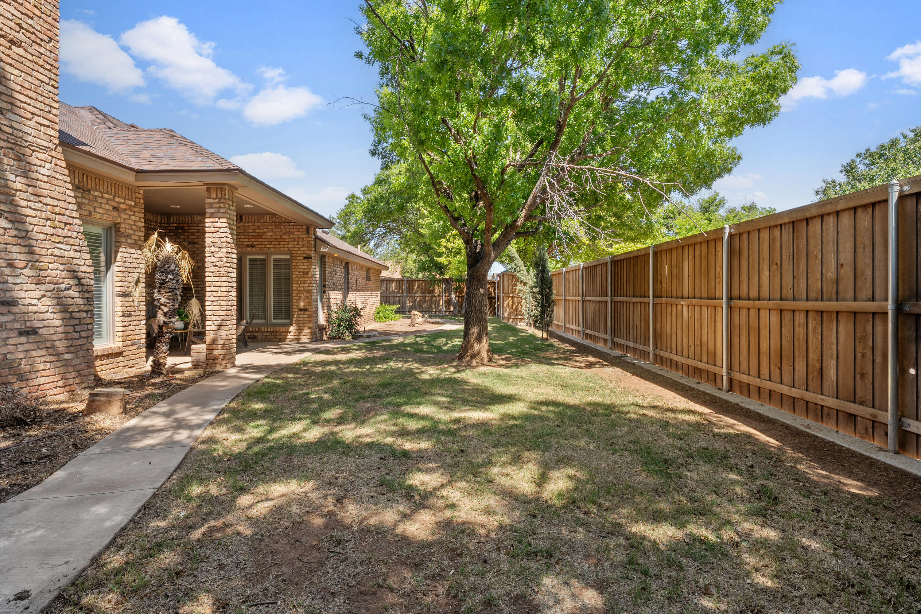 102 North Utica Avenue Lubbock, TX 79416 - Photo 34 of 36 a backyard of a house with lots of green space