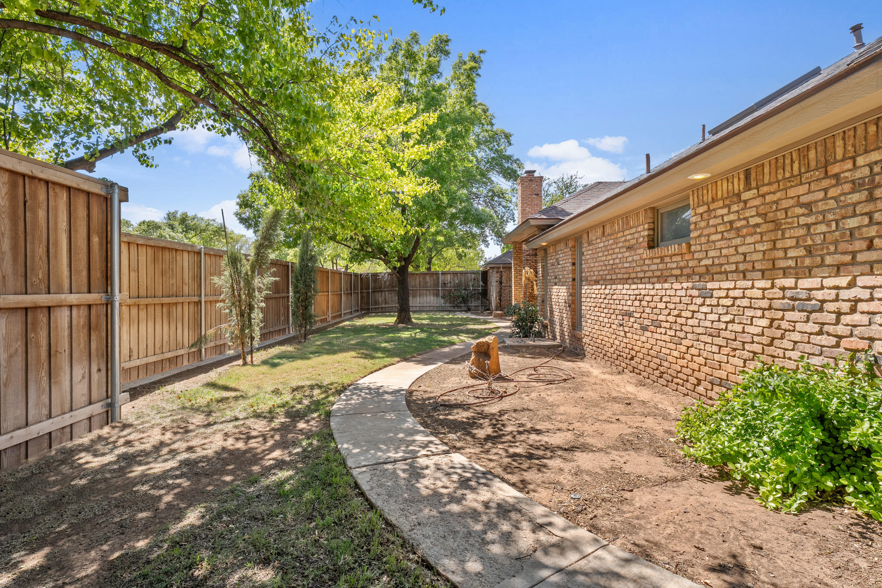 102 North Utica Avenue Lubbock, TX 79416 - Photo 36 of 36 a view of a backyard with wooden fence