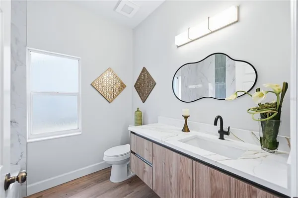 a bathroom with a double vanity sink and a mirror