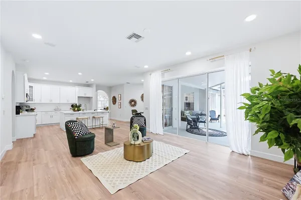 a living room with furniture a couch and a potted plant