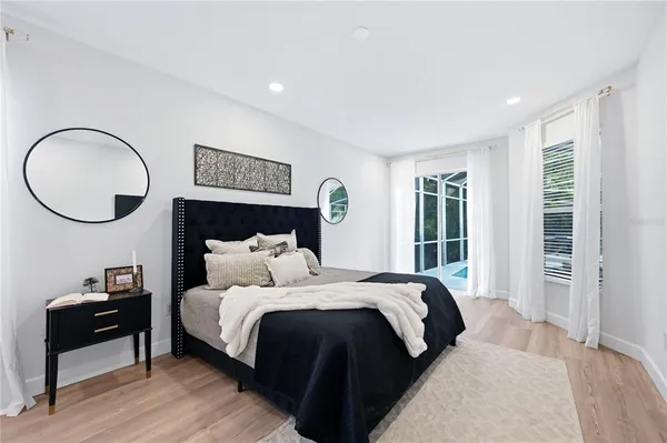 a bed room with a bed mirror and a window