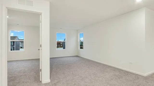 an empty room with entrance and windows
