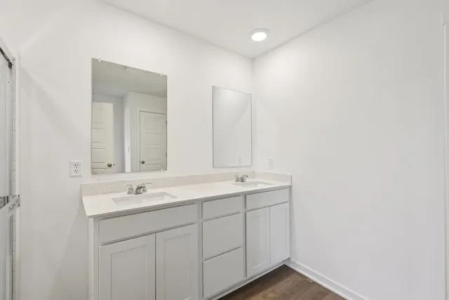 a bathroom with a double vanity sink and mirror