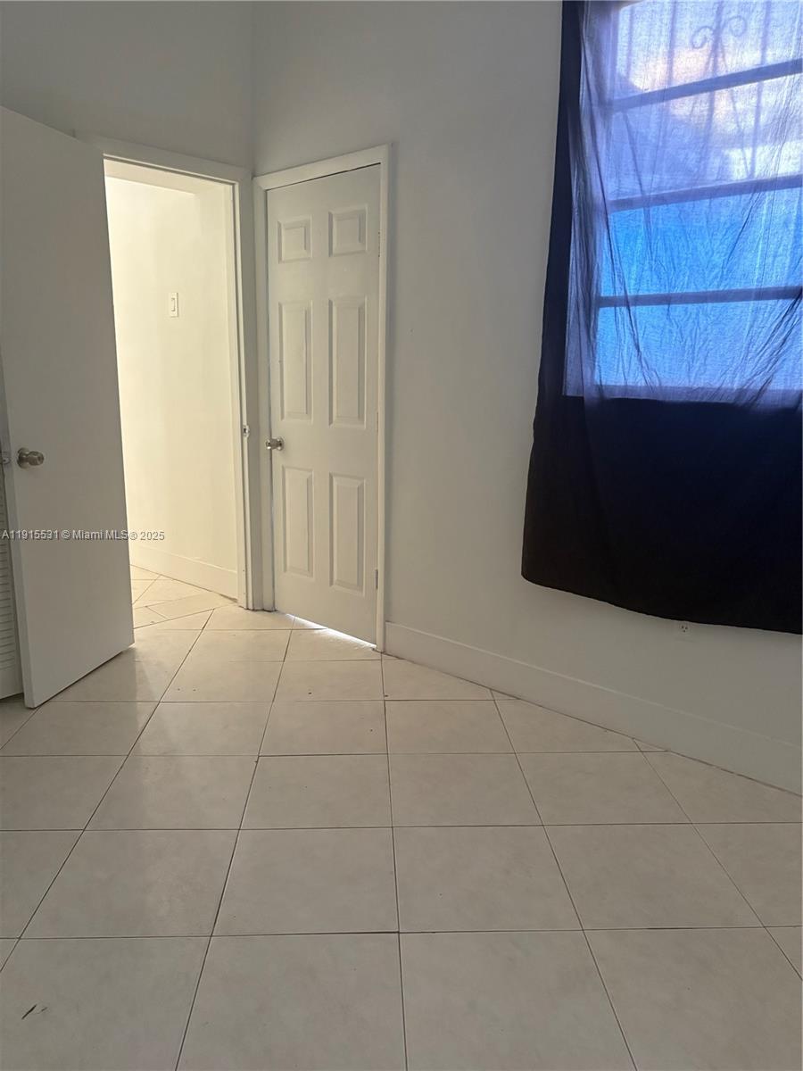 927 Southwest 9th Avenue, Unit 1 Miami, FL 33130 - Photo 13 of 16 a view of an empty room with a window