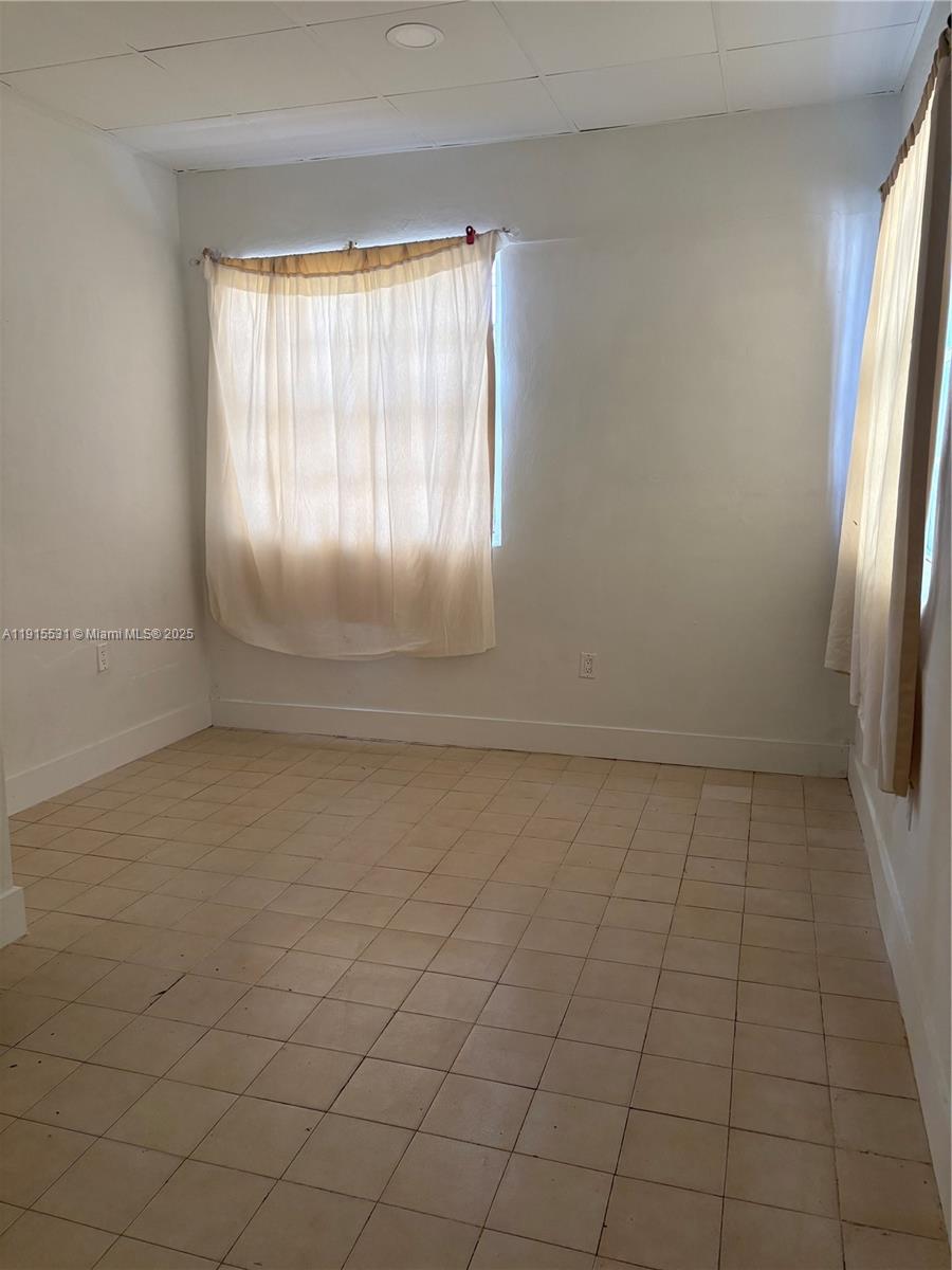 927 Southwest 9th Avenue, Unit 1 Miami, FL 33130 - Photo 14 of 16 an empty room with windows