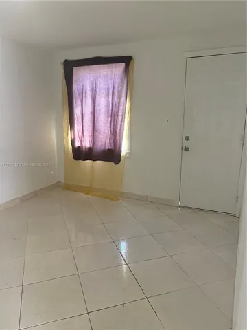 a view of an empty room and window