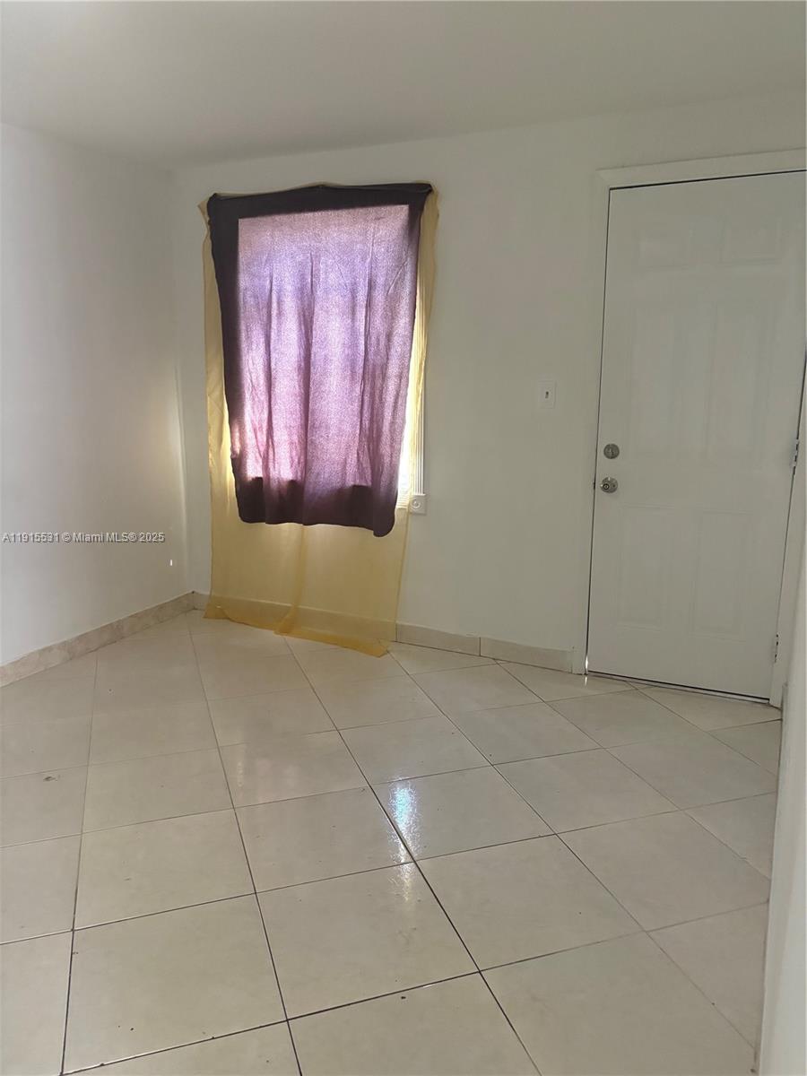 927 Southwest 9th Avenue, Unit 1 Miami, FL 33130 - Photo 4 of 16 a view of an empty room and window