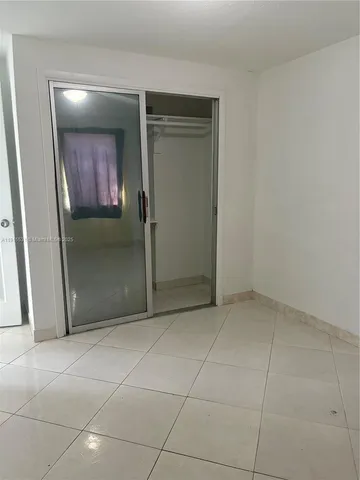 an empty room with a mirror