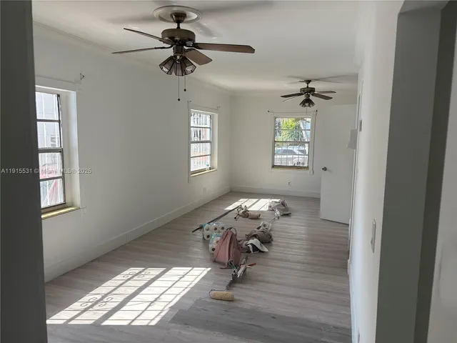 a living room with furniture window and wooden floor