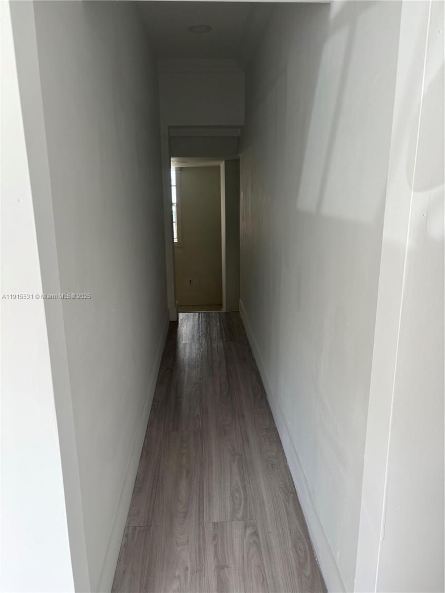 927 Southwest 9th Avenue, Unit 1 Miami, FL 33130 - Photo 8 of 16 a view of a hallway with wooden floor