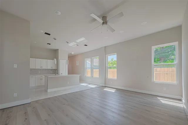 a view of a kitchen with furniture and wooden floor
