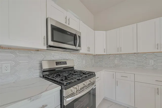 a kitchen with a sink a stove a refrigerator and a stove top oven