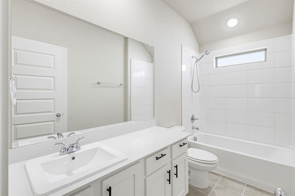 2108 Mossfield Lane Forney, TX 75126 - Photo 21 of 28 Bathroom featuring a white vanity with an integrated sink, chrome faucet, and black cabinet hardware