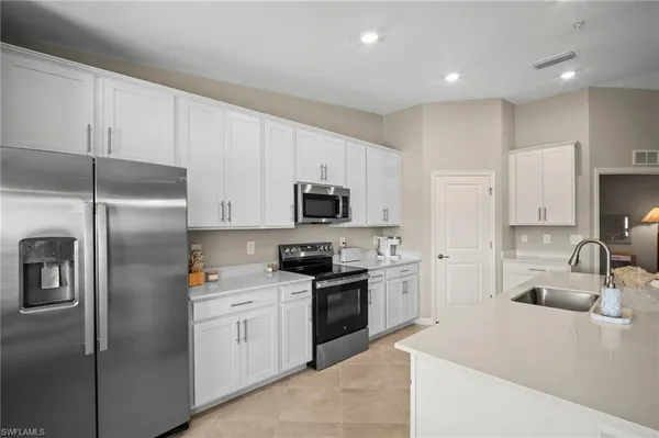 a kitchen with a sink stainless steel appliances and cabinets