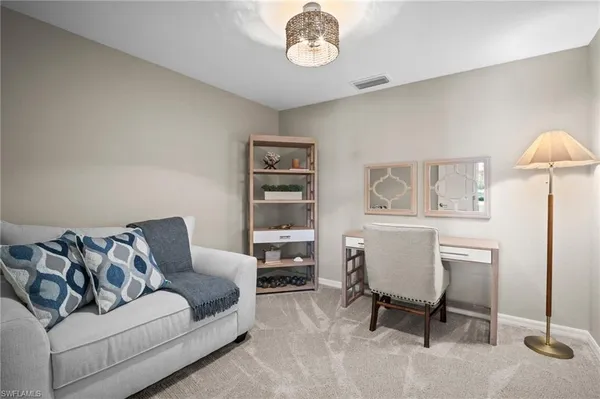 a living room with furniture a window and a table