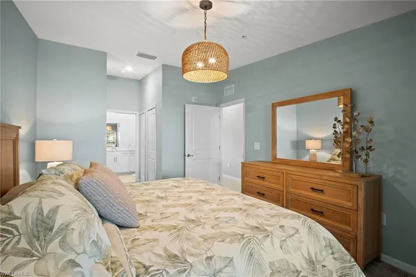a bedroom with a bed and a chandelier