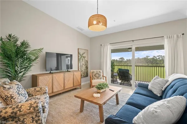 a living room with furniture and a large window