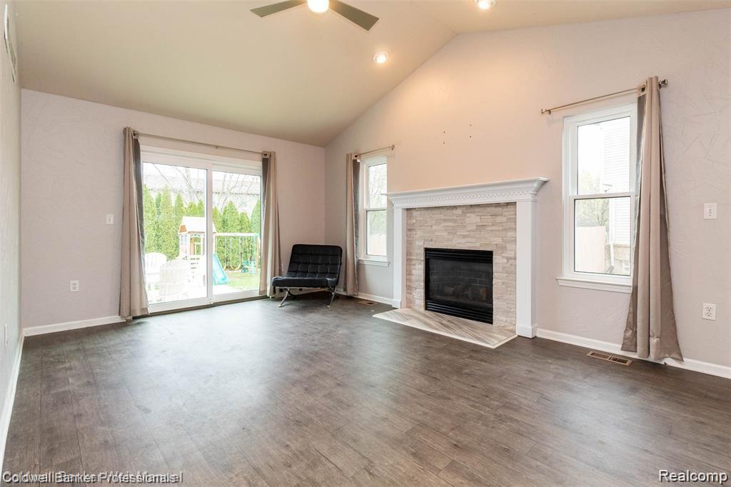 8263 Jeremy Road Belleville, MI 48111 - Photo 14 of 29 Spacious Family Room with newer vinyl flooring (looks like wood, really!), gas FP and doorwall to deck