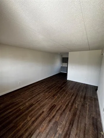 a view of room with wooden floor