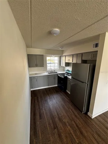 a kitchen with stainless steel appliances a refrigerator and a sink