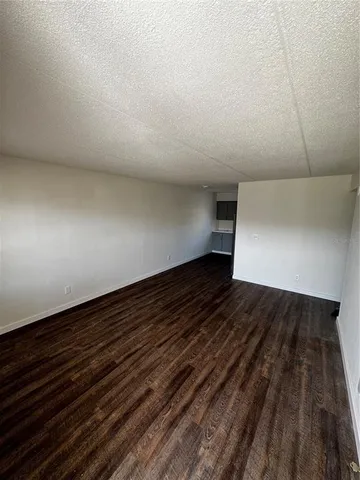 a view of room with wooden floor