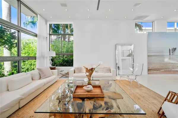 a living room with furniture and a potted plant