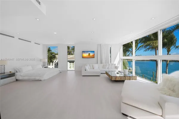 a bedroom with a large bed and a large window