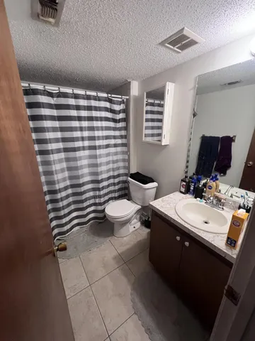 a bathroom with a sink a toilet and mirror