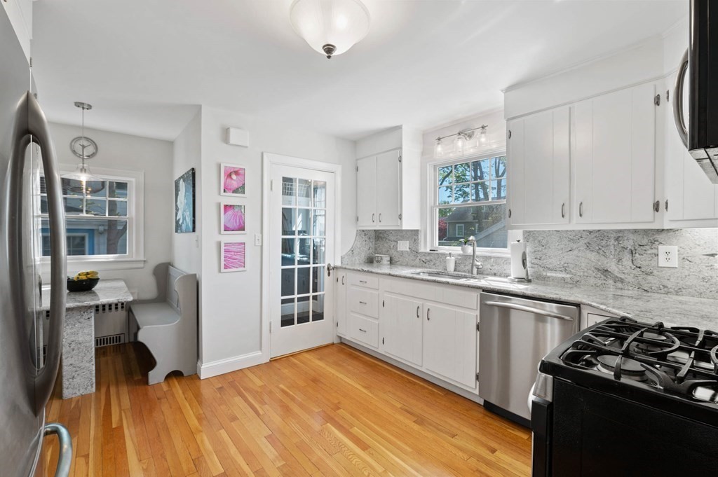 28 Columbia Road Marblehead, MA 01945 - Photo 18 of 42 a kitchen with stainless steel appliances granite countertop a sink stove and refrigerator
